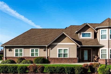 dark brown house with dark green metal roof|brown shingles house color.